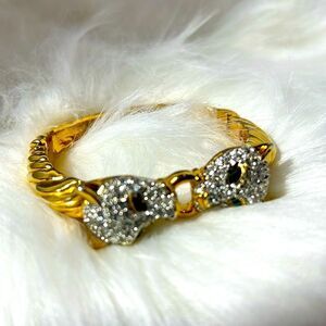 Good Tone Vintage Hinged Bracelet with Rhinestone Jaguars and Green Eyes.WA269